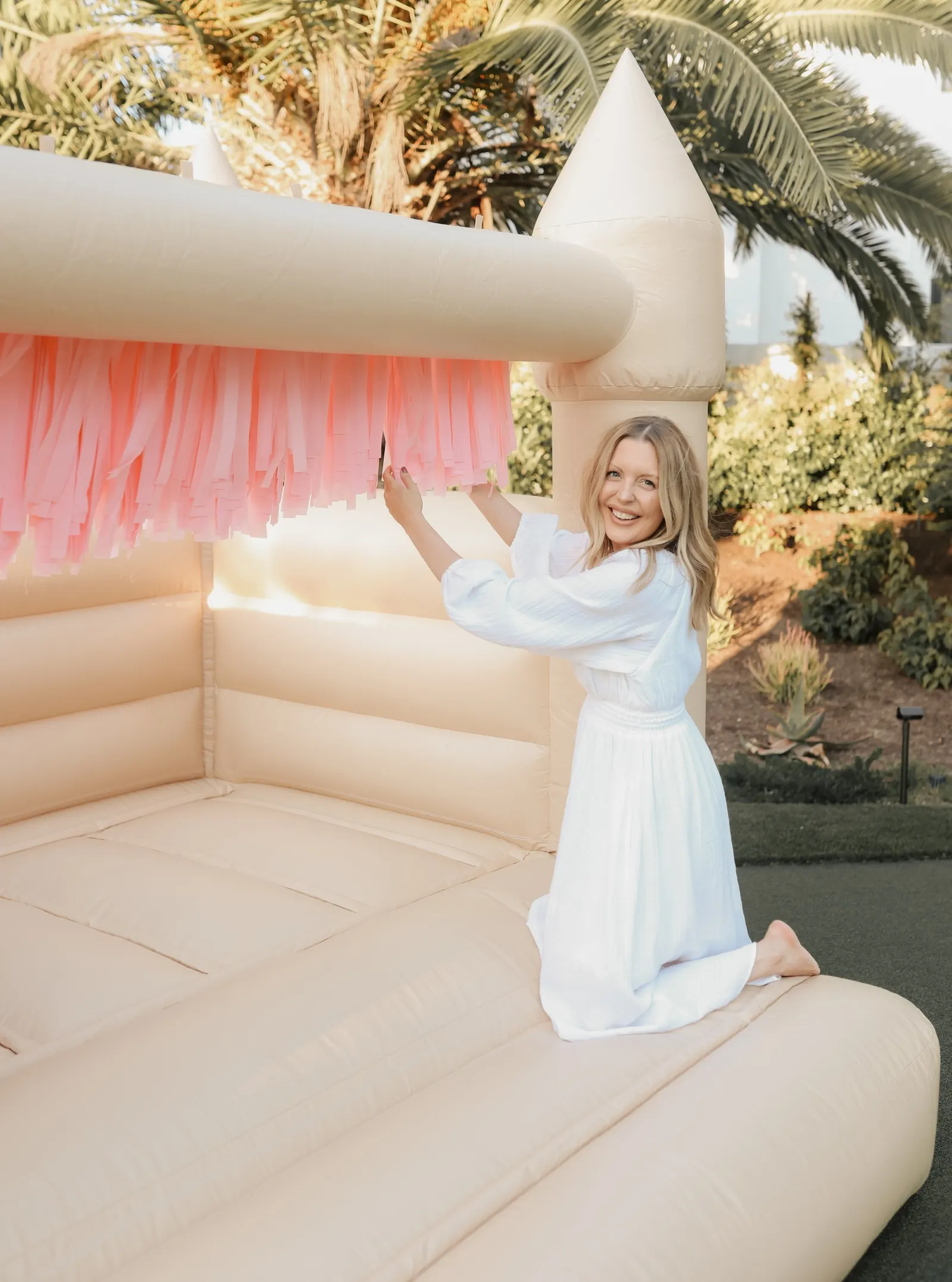 Hand-tied fringe panels on a white bounce house