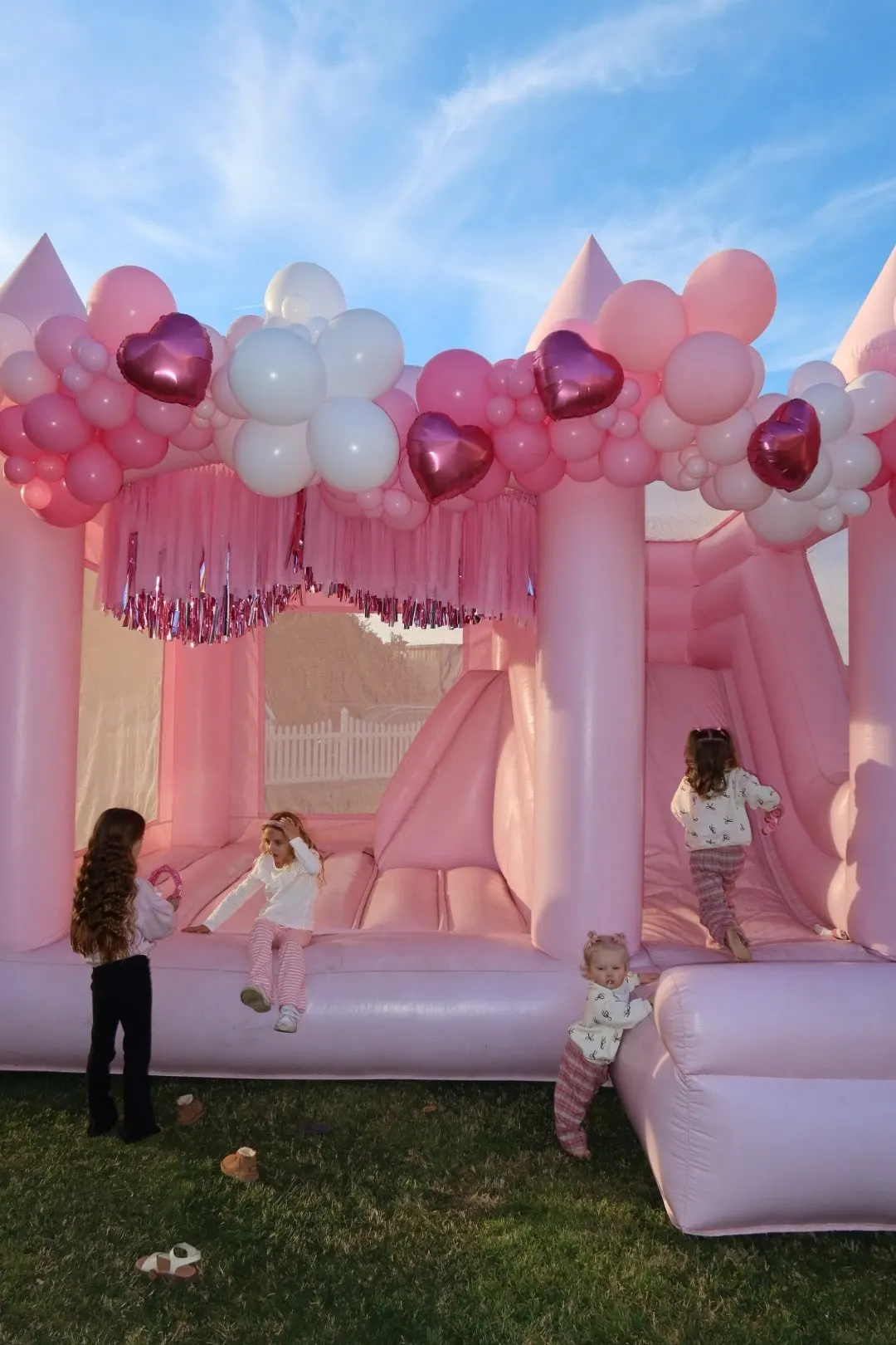 Hand-tied fringe panels on a white bounce house
