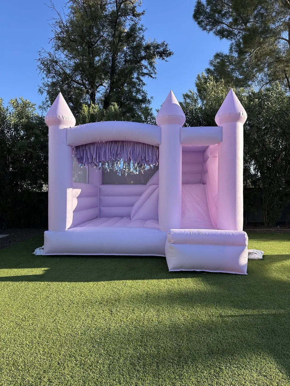 Hand-tied fringe panels on a white bounce house