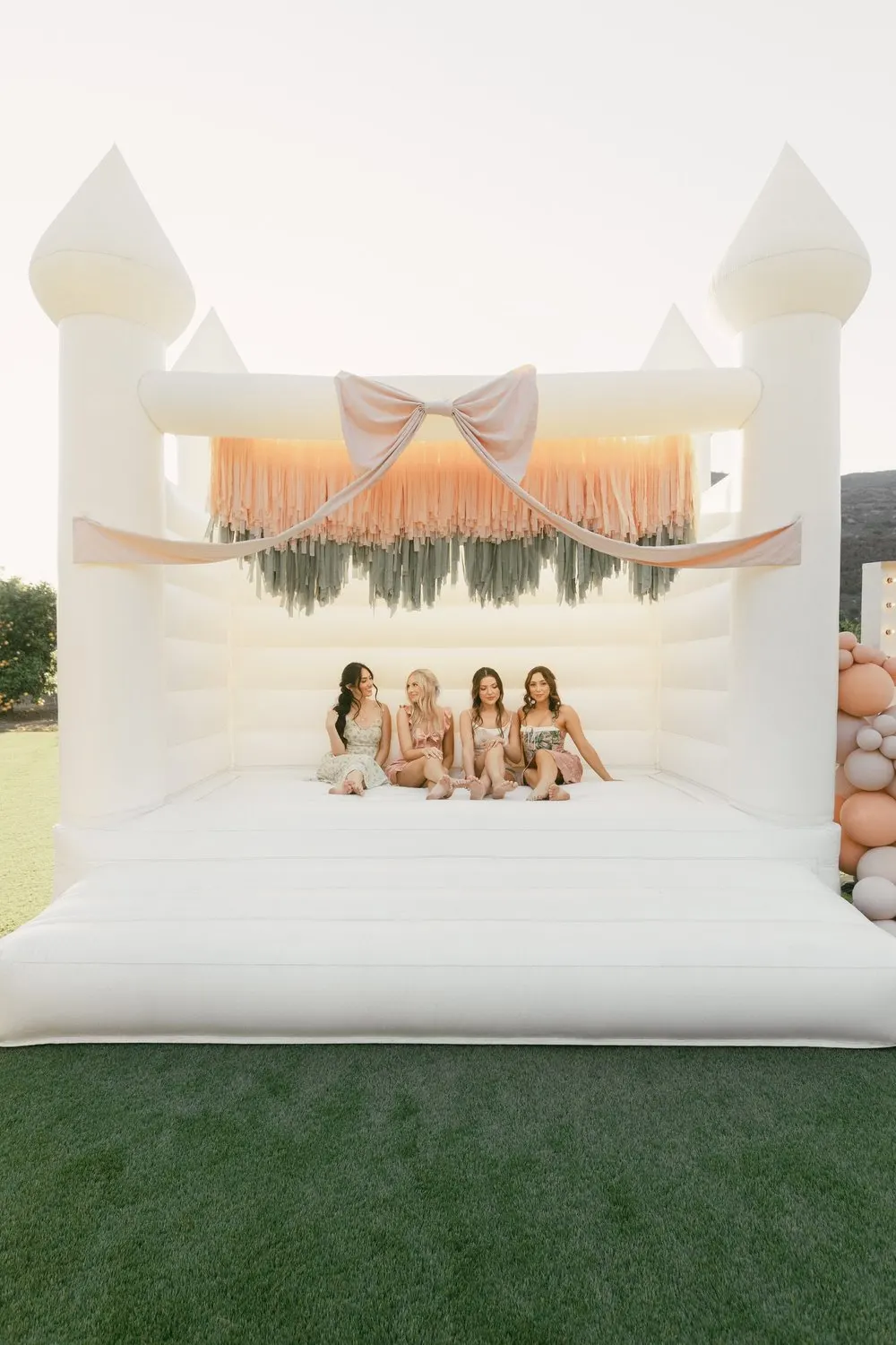 Hand-tied fringe panels on a white bounce house