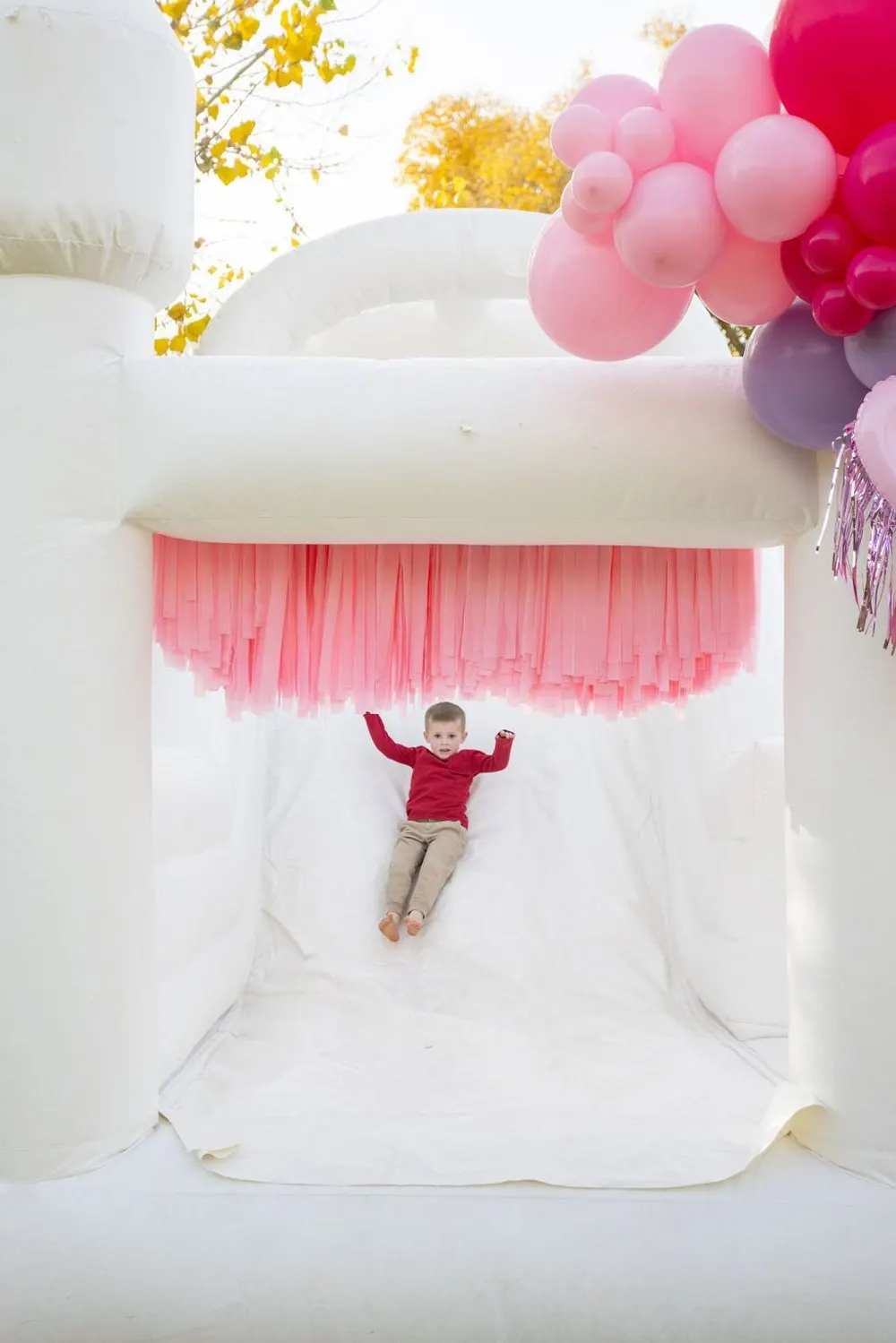 Hand-tied fringe panels on a white bounce house