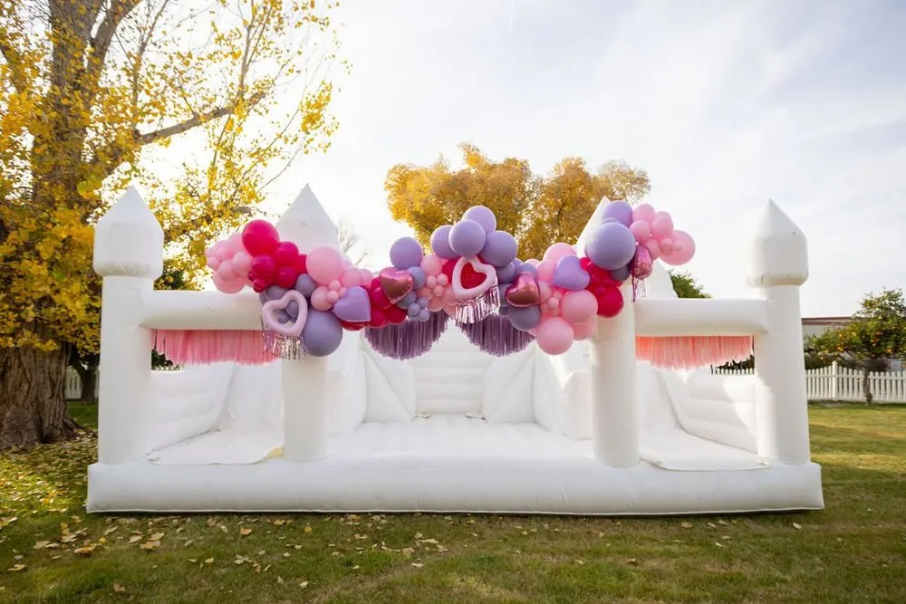 Hand-tied fringe panels on a white bounce house